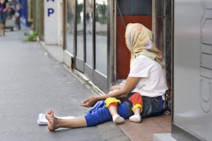 Woman beggar asking for money