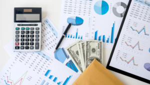 documents, calculator and money spread in a desktop