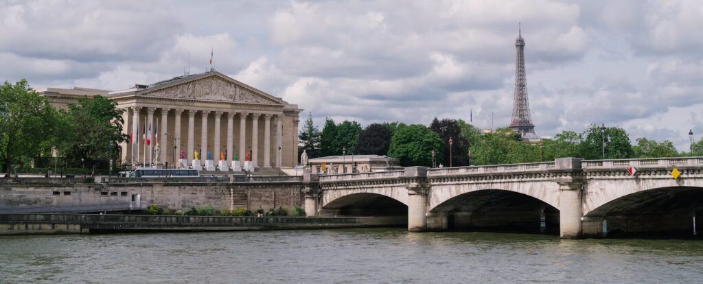 a bridge in paris with the eiffel tower in the distance